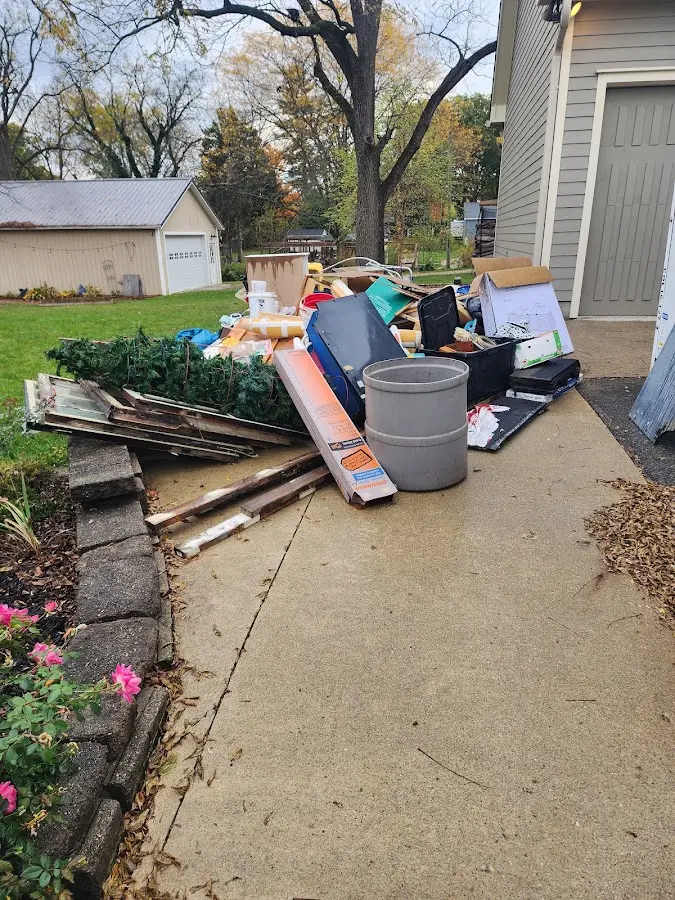 Dumpster being loaded with debris for Estate Cleanout Dumpster Rental in Springhill